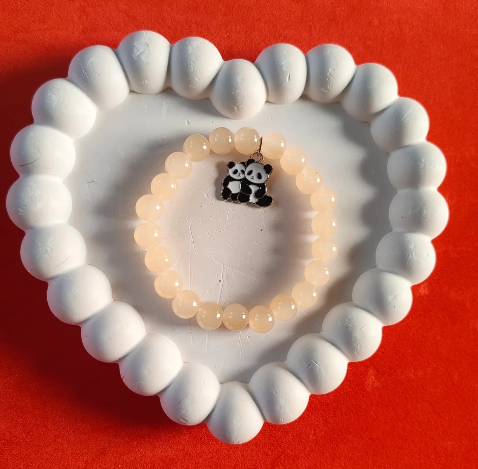 Peach Panda Charm BraceletEnhance your daily aesthetic with this peach beaded stretch bracelet. Showcasing a cute enamel 1