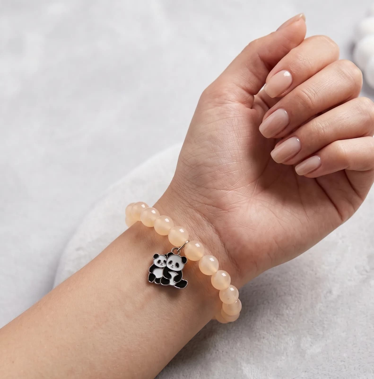 Peach Panda Charm BraceletEnhance your daily aesthetic with this peach beaded stretch bracelet. Showcasing a cute enamel 2
